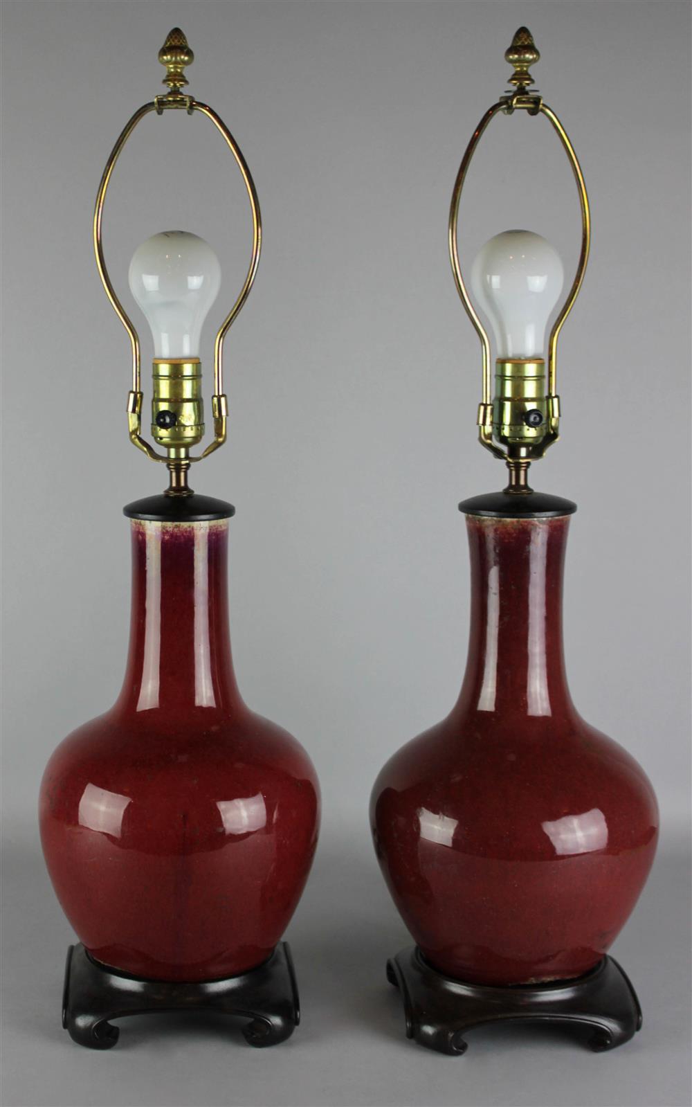 Appraisal: PAIR OF CHINESE SANG-DE-BOEUF-GLAZED LAMPS the bottle form vases drilled