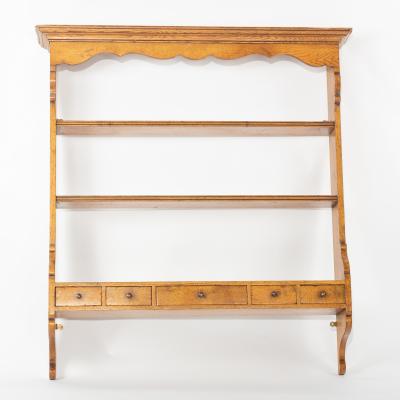 Appraisal: A set of pine hanging shelves with five drawers beneath