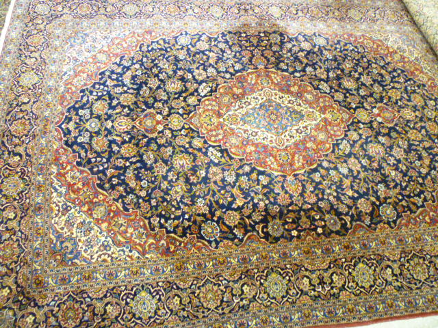 Appraisal: A KASHAN CARPET the navy blue field with trailing flowering