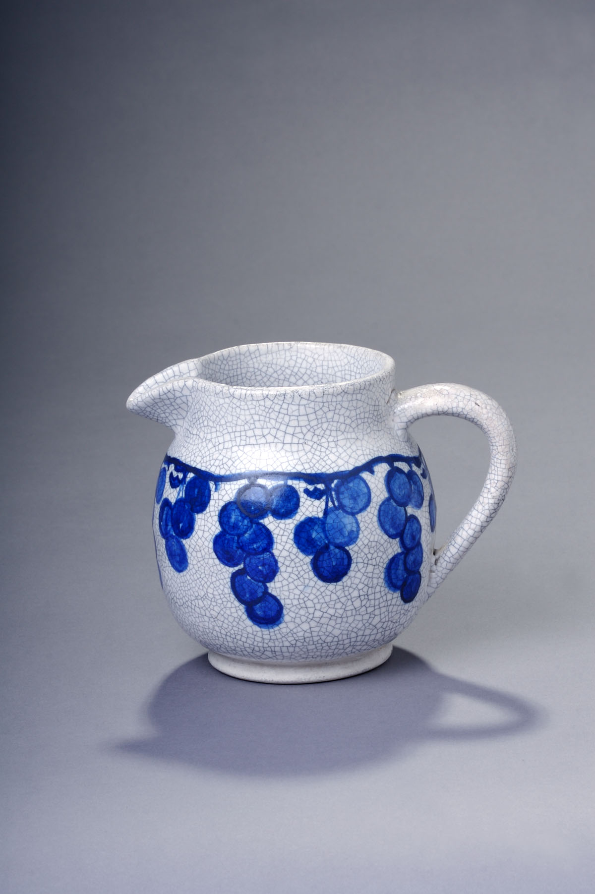 Appraisal: DEDHAM POTTERY 'GRAPE' PATTERN PITCHER Of bulbous form with down-turned