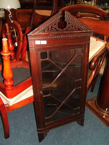 Appraisal: A late Victorian mahogany corner cabinet with single glazed door