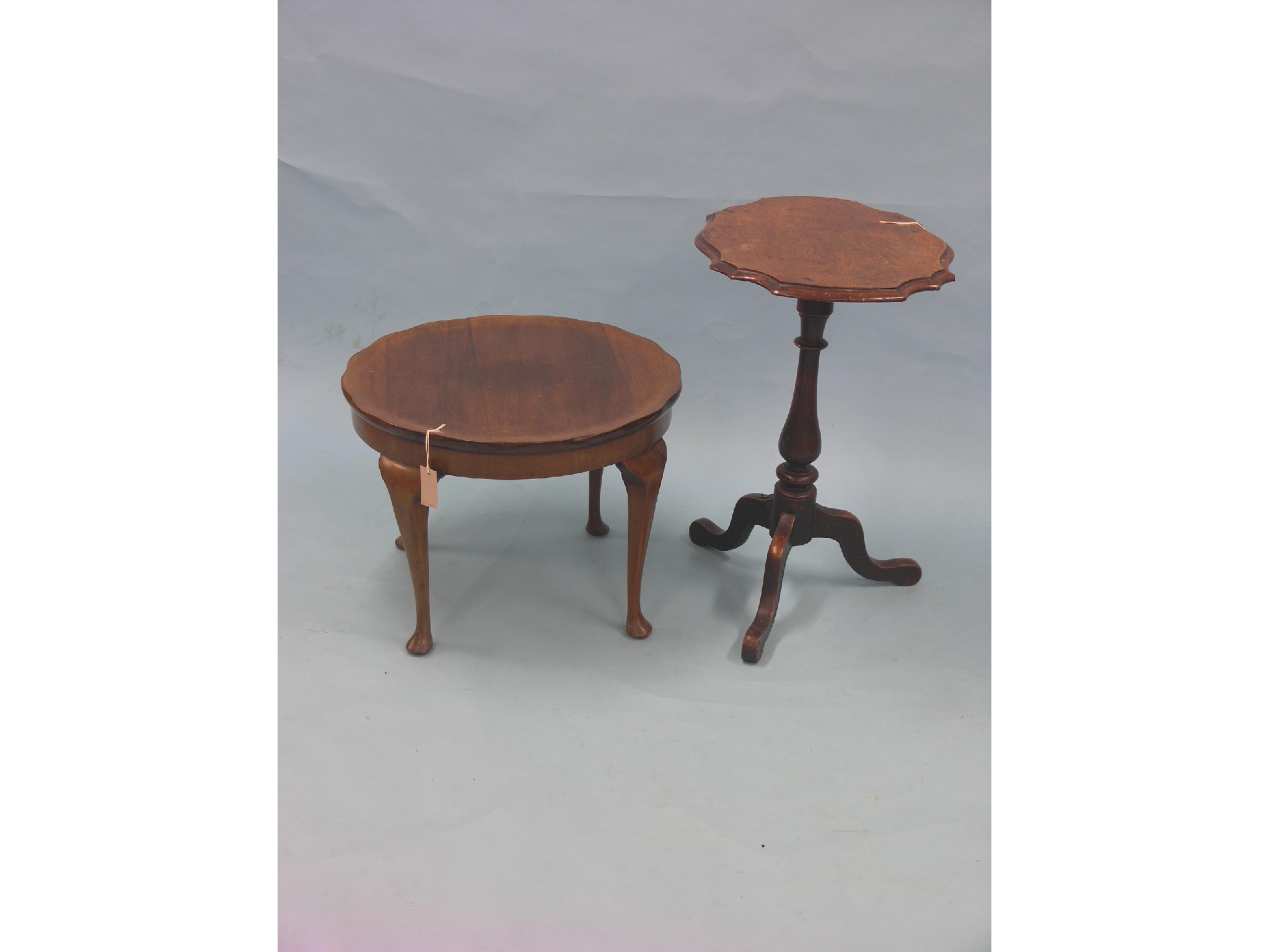 Appraisal: A Victorian walnut occasional table serpentine-shaped top on baluster stem