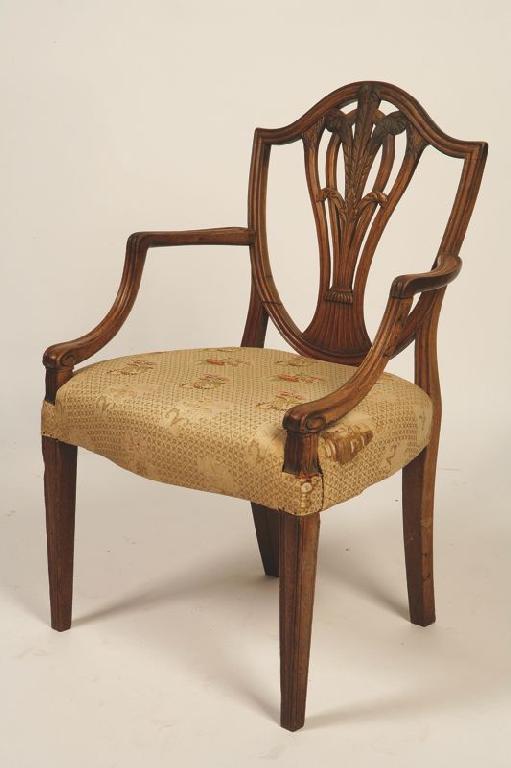 Appraisal: A GEORGE III MAHOGANY SHERATON DESIGN ELBOW CHAIR the shield