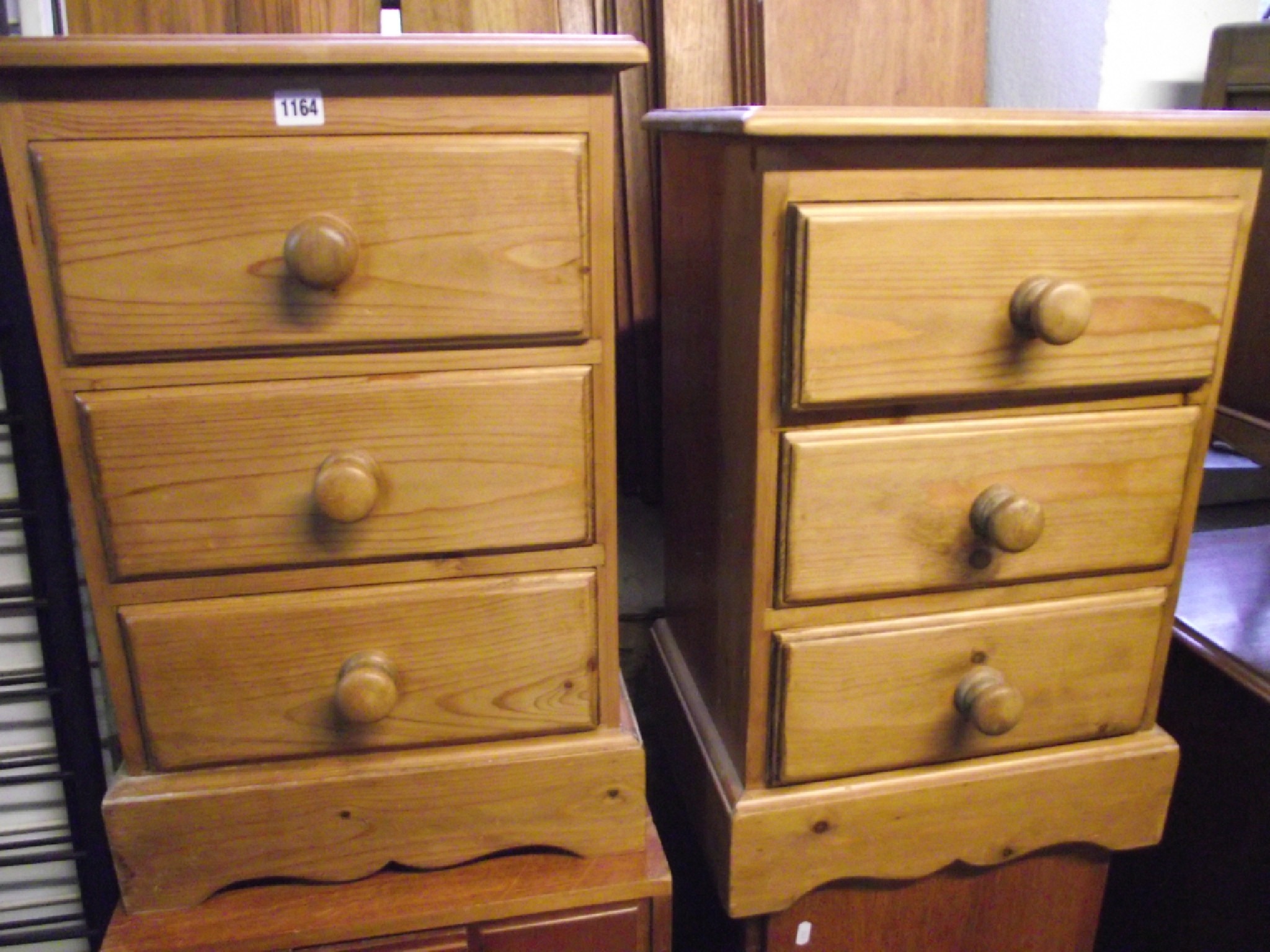 Appraisal: A pair of solid pine three drawer bedside chests with