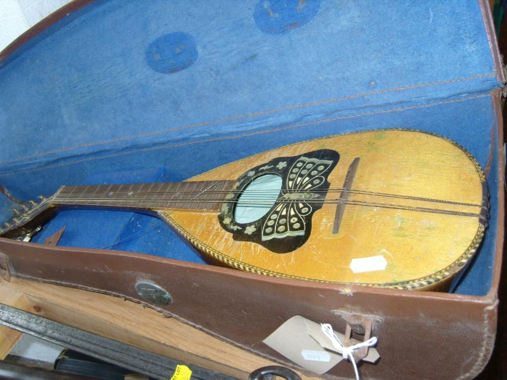 Appraisal: A cased mandolin with inlaid mother of pearl decoration