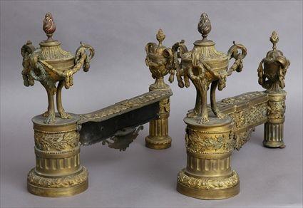 Appraisal: PAIR OF LOUIS XVI-STYLE GILT-BRONZE CHENETS Each with husk-hung tripod