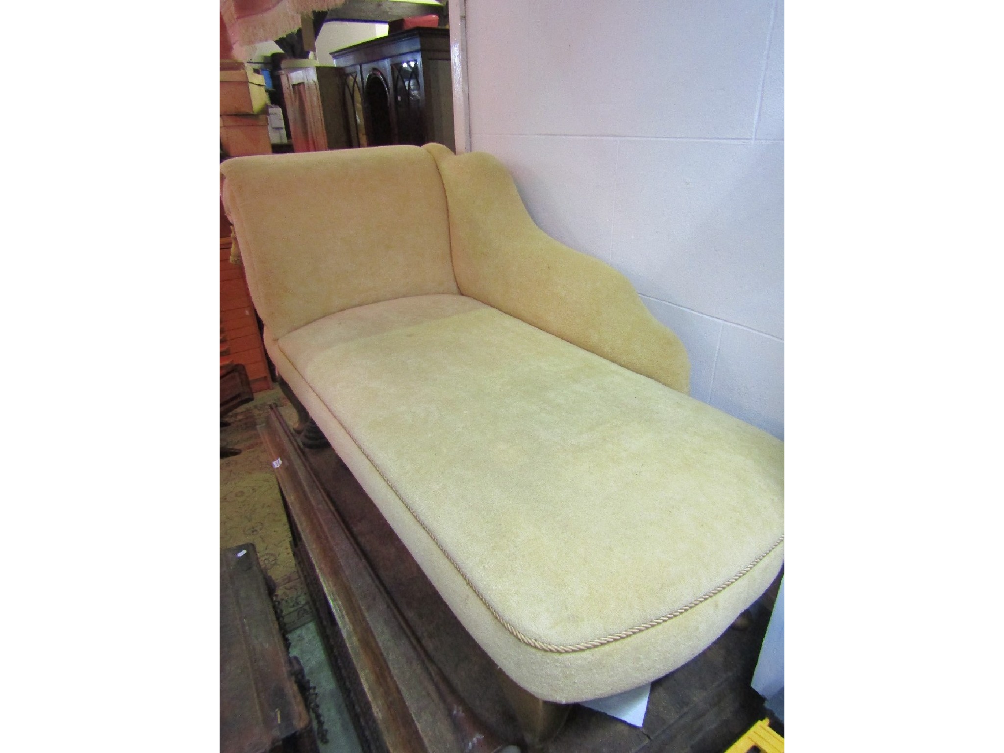 Appraisal: A small contemporary chaise lounge with upholstered seat shaped back