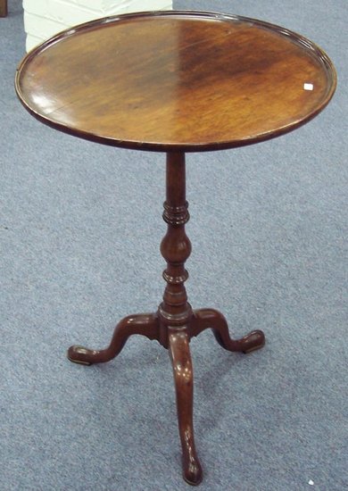 Appraisal: A circular mahogany table on a tripod support cm wide