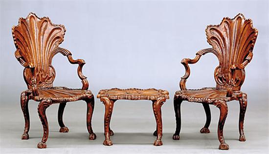 Appraisal: Pair Continental carved hardwood armchairs with footstool extensively carved with