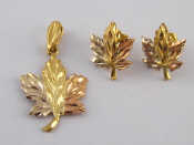 Appraisal: A three colour metal tests carat gold pendant and earrings