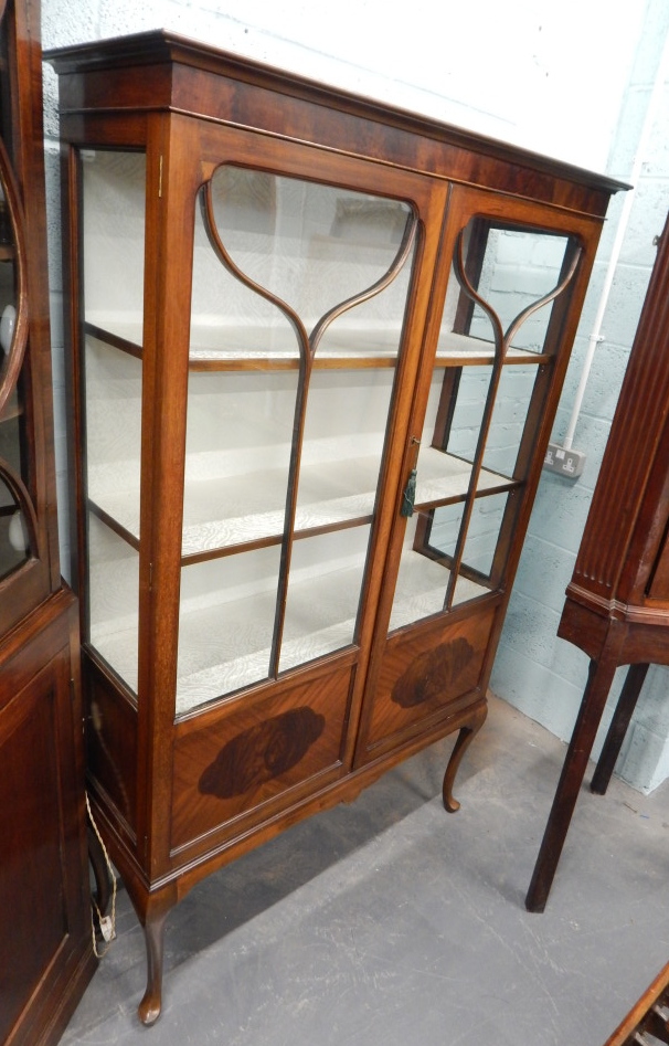 Appraisal: An early thC mahogany display cabinet with two glazed doors