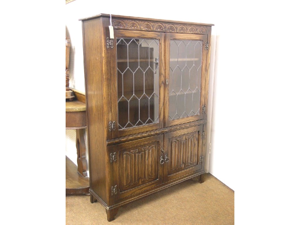 Appraisal: A reproduction solid dark oak display cabinet pair of leaded