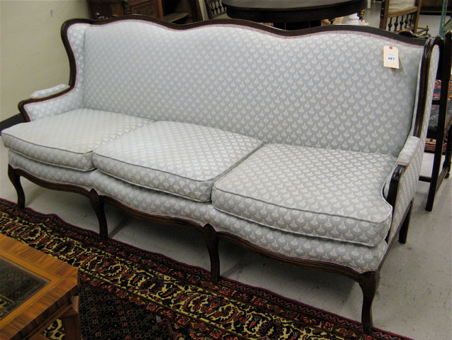 Appraisal: PROVINCIAL STYLE WINGBACK SOFA with light blue upholstery and molded