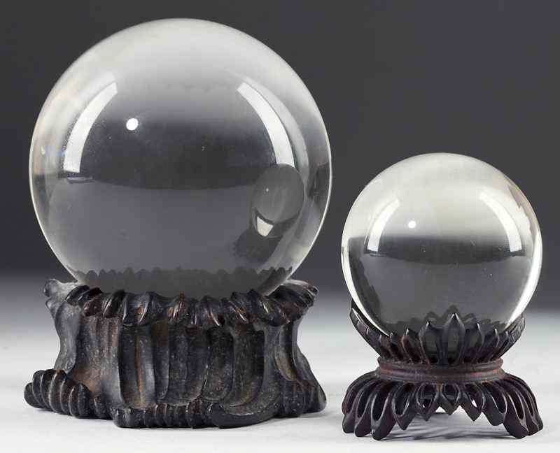 Appraisal: Two Chinese Optic Glass Orbseach resting on carved and pierced