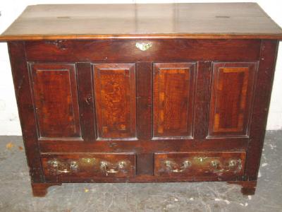 Appraisal: AN OAK PANELLED CHEST the later plank top with moulded