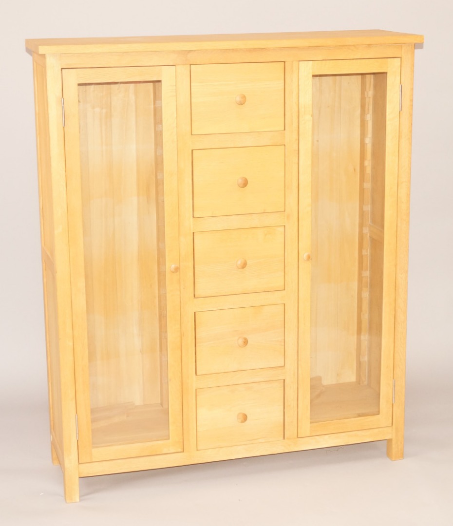 Appraisal: An oak display cabinet with five drawers flanked by two