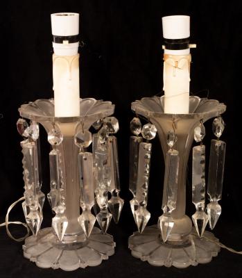 Appraisal: A pair of clear glass lustres hung elongated drops on