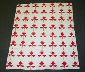 Appraisal: Hand stitched red and white quilt with maple leaf designs