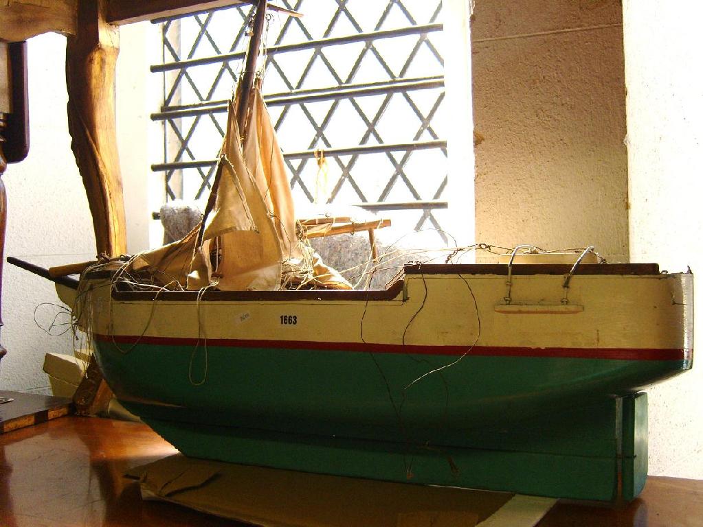 Appraisal: A timber model of a masted ship with linen sails