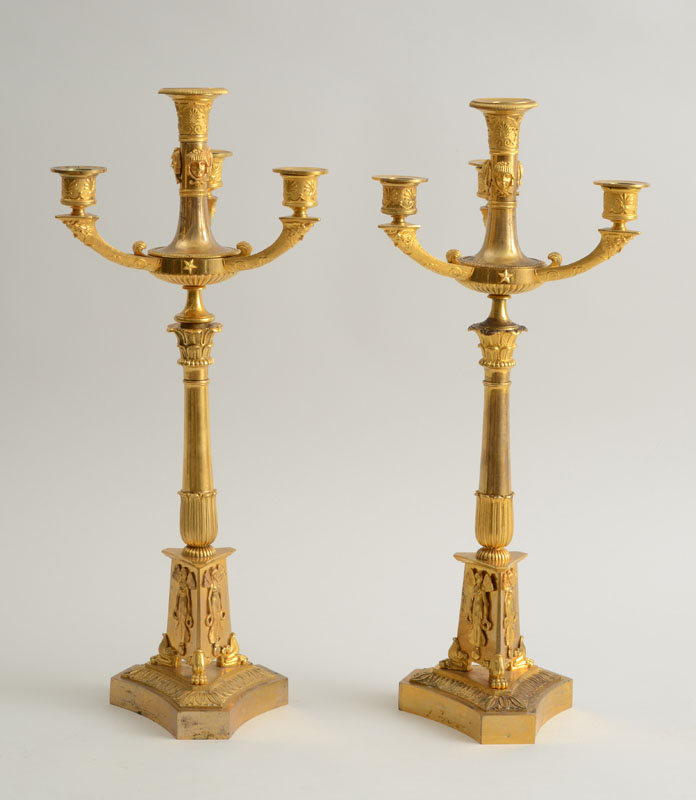 Appraisal: PAIR OF EMPIRE ORMOLU TWO-PIECE FOUR-LIGHT CANDELABRA Each flared leaf-banded