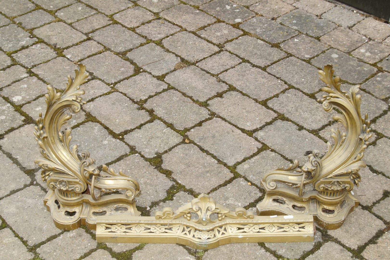 Appraisal: A thC French gilt brass fire fender comprising two foliate