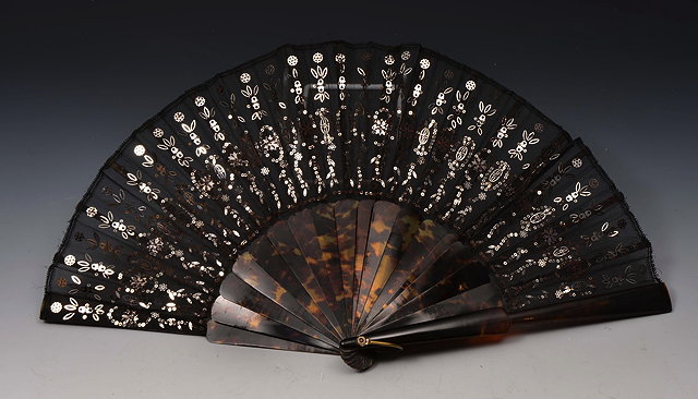 Appraisal: A SPANISH FAN with faux tortoiseshell sticks and silk with