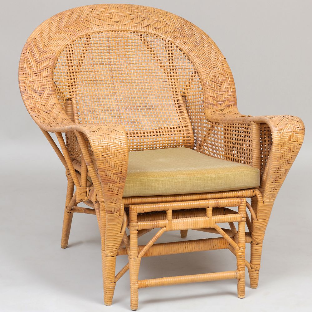 Appraisal: Large Wicker Arm Chair with Retractable Footrest The armrests fitted