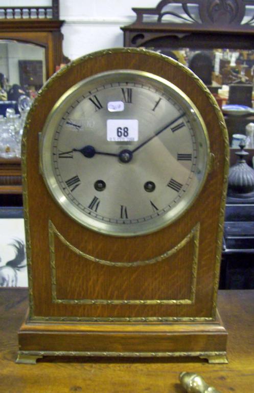 Appraisal: An Edwardian oak cased mantel clock with silvered dial key