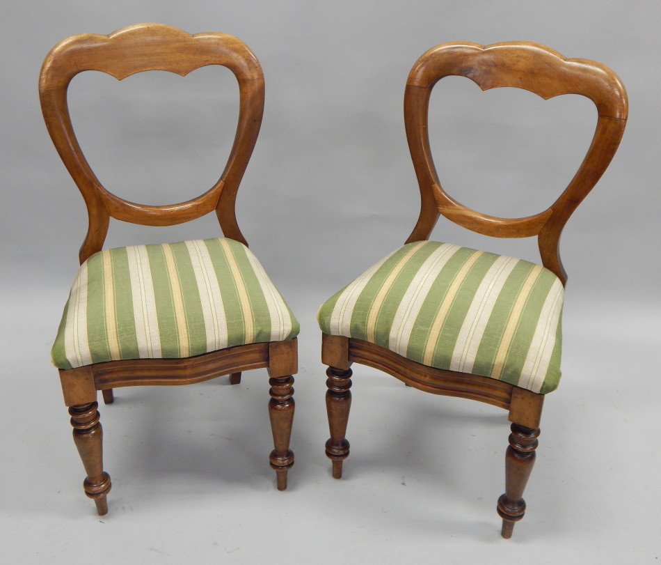 Appraisal: A pair of Victorian walnut balloon back chairs each with