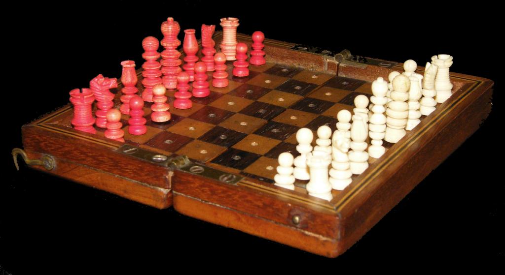 Appraisal: Miniature stained ivory travelling chess set with original mahogany inlaid