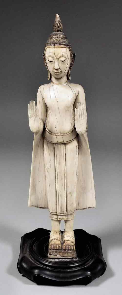 Appraisal: A South East Asian ivory carving of a standing Buddha