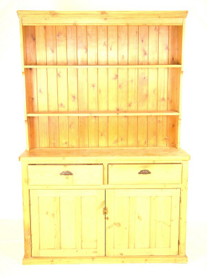 Appraisal: A pine dresser the moulded cornice above plate racks over