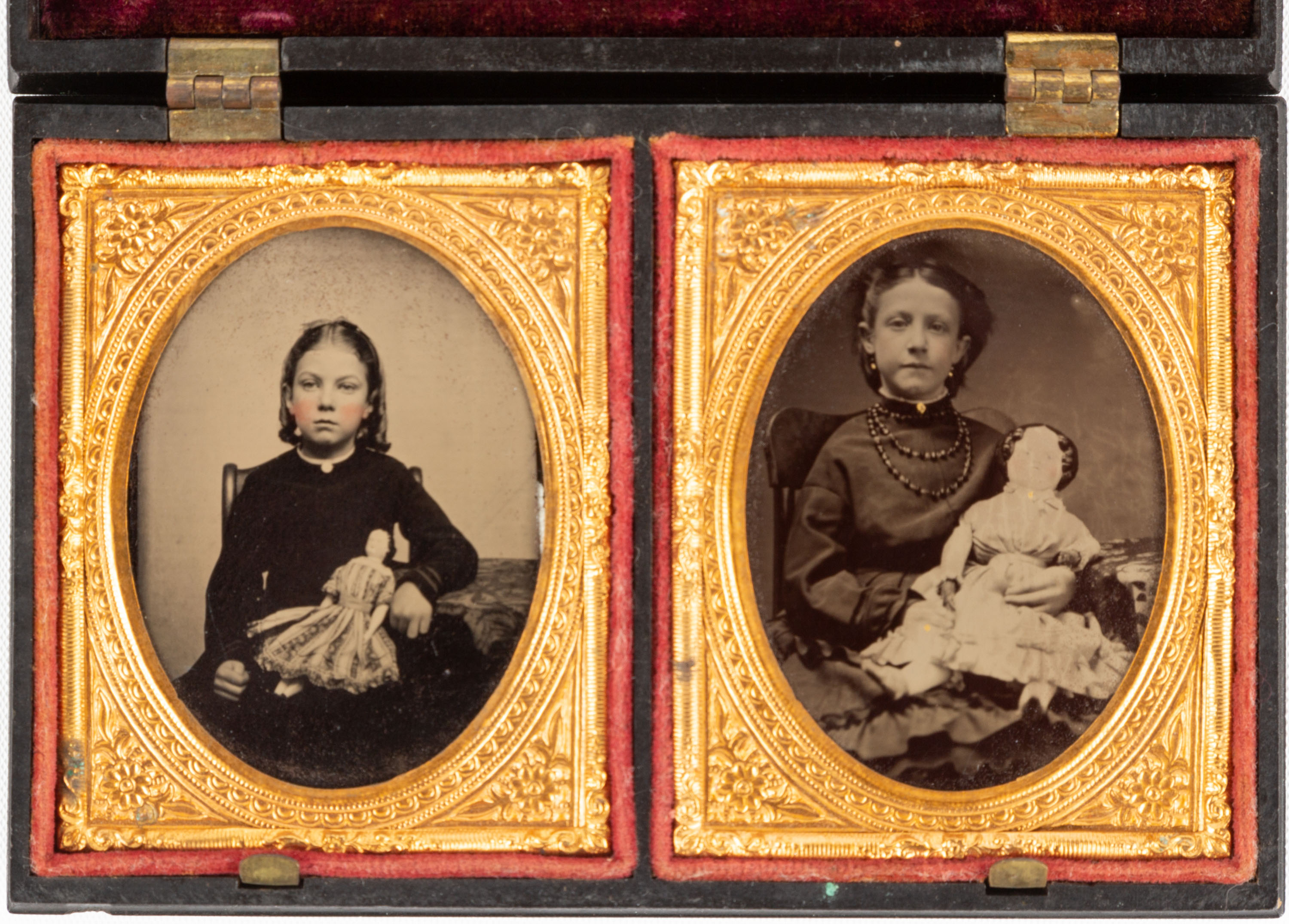 Appraisal: DOUBLE TINTYPE OF YOUNG GIRLS WITH DOLLS th century Gutta-percha