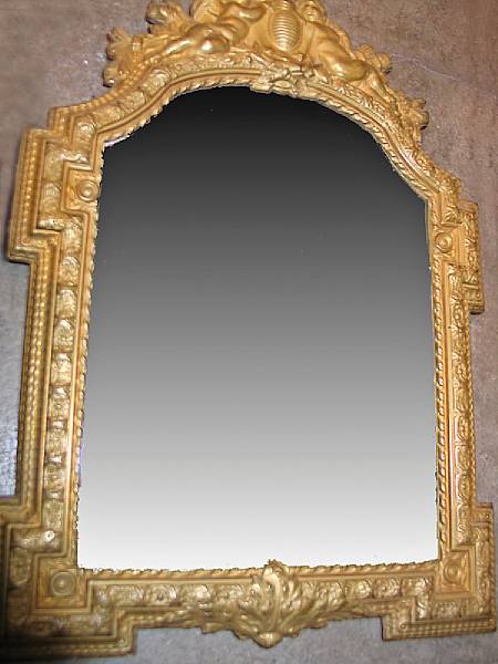 Appraisal: A pair of Baroque style brass repouss mirrors Each with