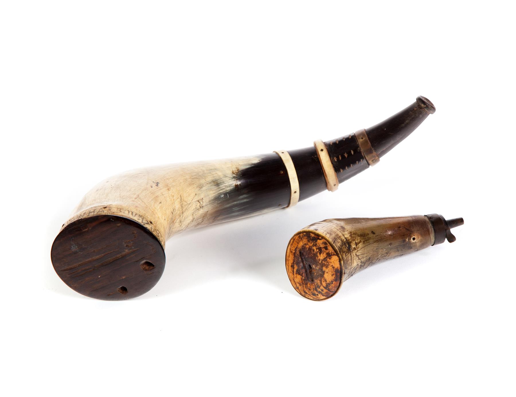 Appraisal: TWO AMERICAN POWDER HORNS Eighteenth- th century Larger has carving