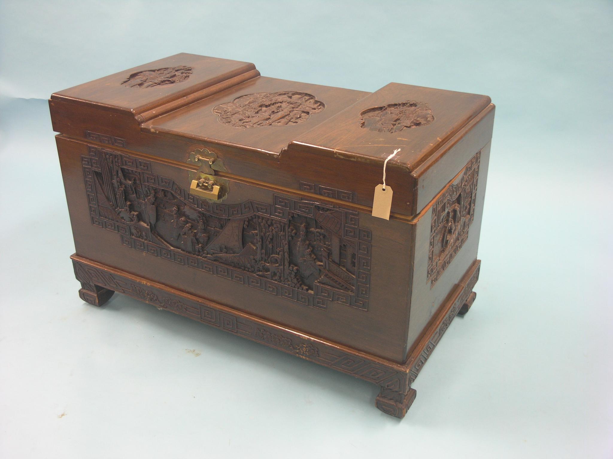 Appraisal: An Oriental camphorwood blanket chest carved throughout with figures and