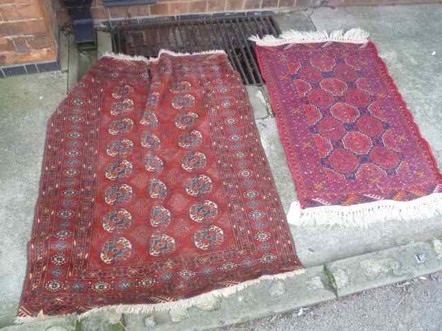 Appraisal: A SMALL PAKISTAN RED GROUND BOKHARA RUG x approx and