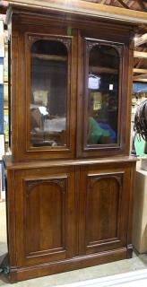 Appraisal: American Victorian style breakfront display cabinet executed in walnut having