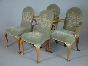 Appraisal: A pair of walnut upholstered open armchairs early th century