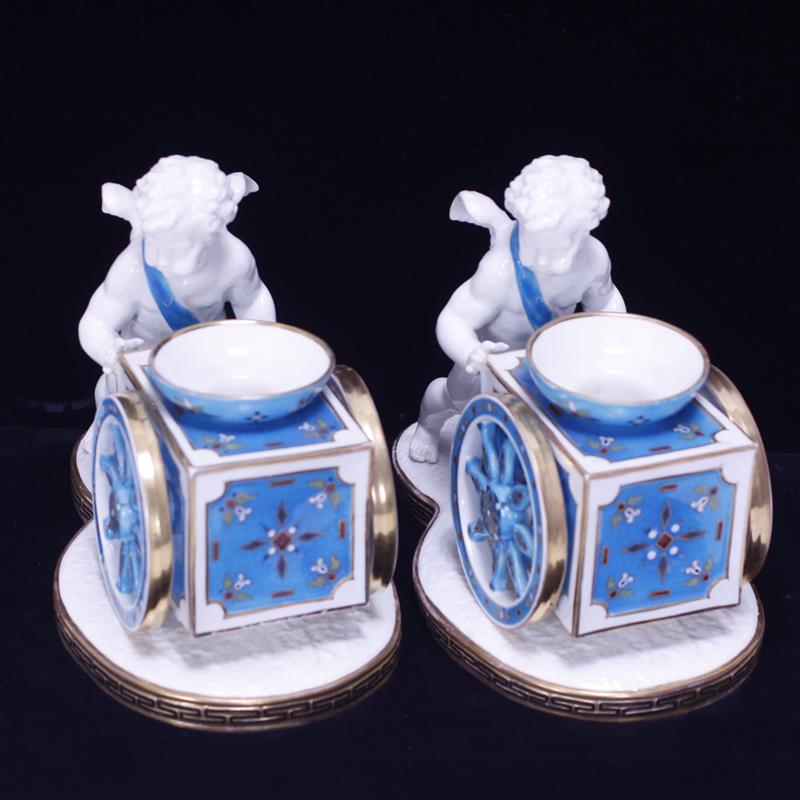 Appraisal: Pair Moore Bros English Porcelain cherub and cart centerpiece candle