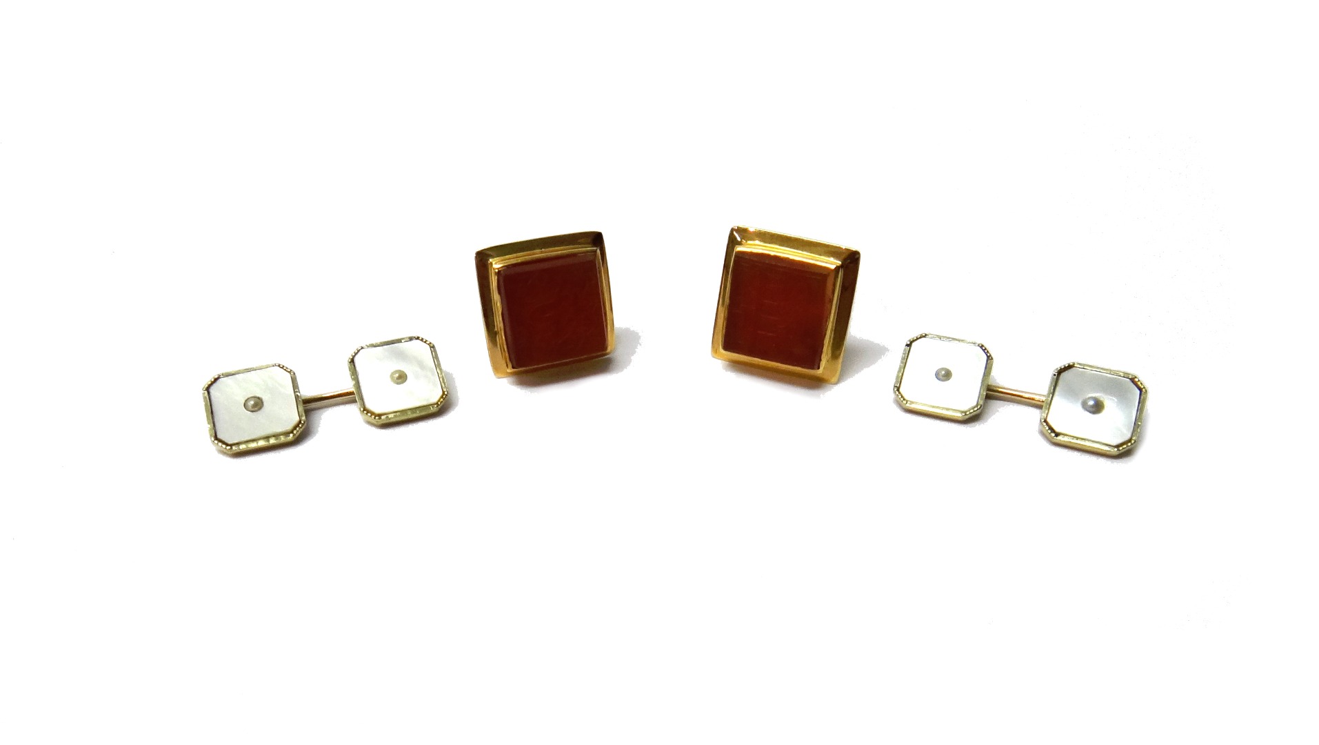 Appraisal: A pair of gold and carved cornelian set dress cufflinks