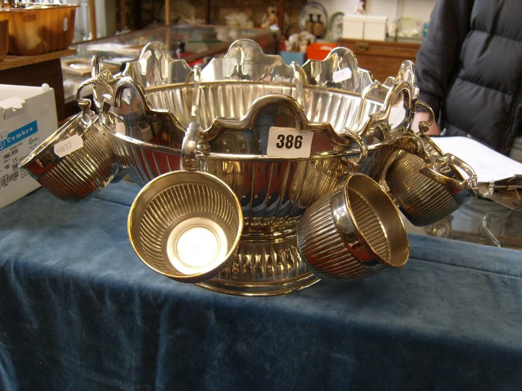 Appraisal: A silver plated punch bowl with shaped rim fitted with