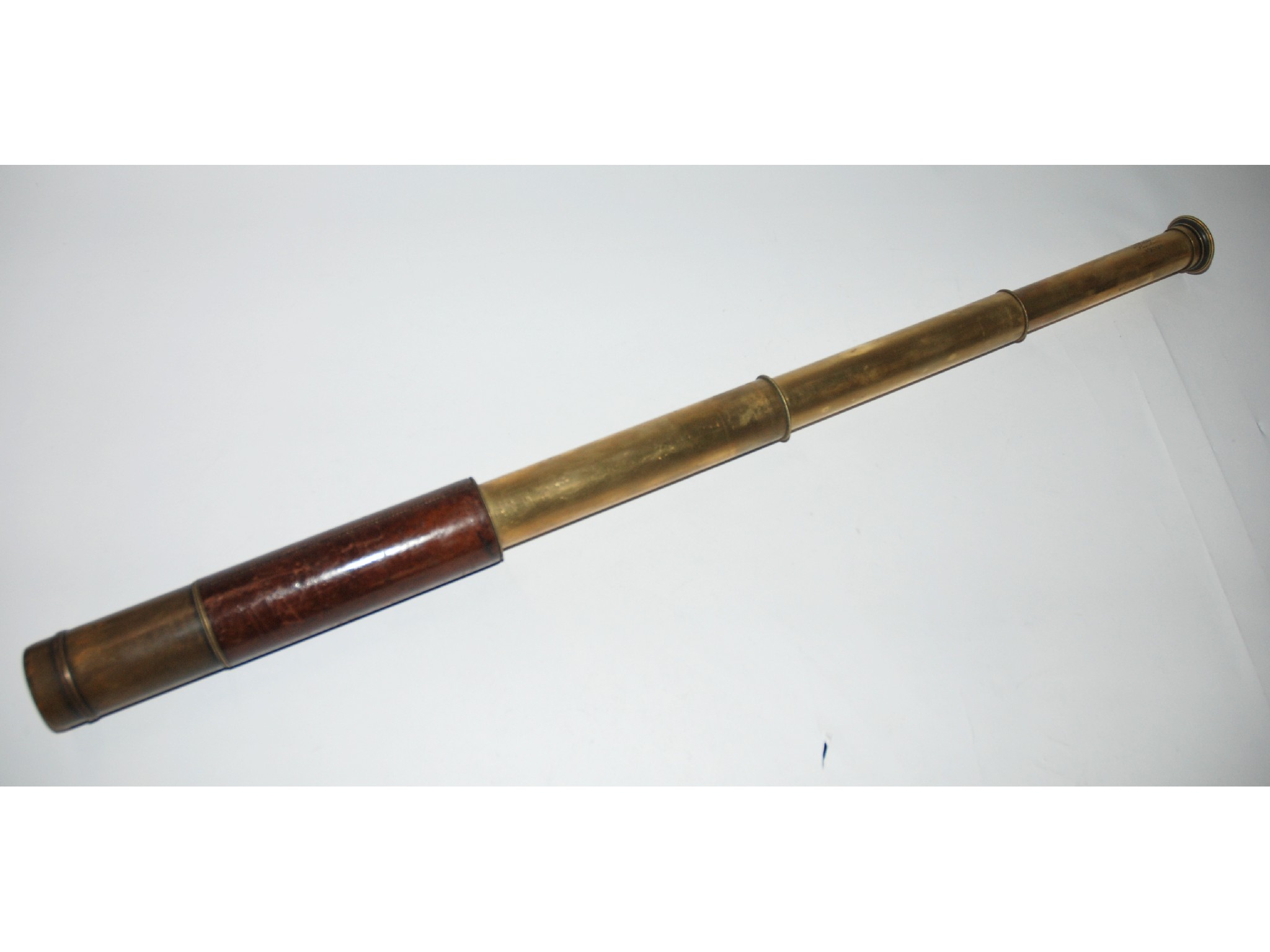 Appraisal: A brass three draw telescope by Ross of London bearing