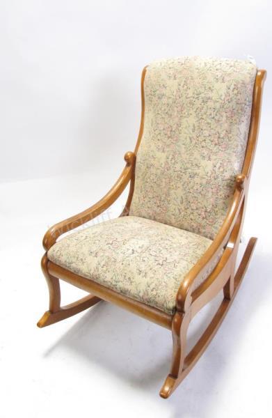 Appraisal: An antique sewing rocker hip rests upholstered back and seat