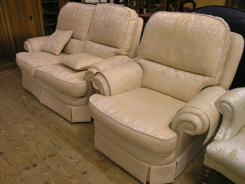 Appraisal: A two seater settee and matching armchair upholstered in an