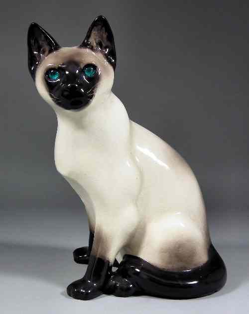 Appraisal: A ''Winstanley'' Kensington pottery Siamese cat with blue glass eyes