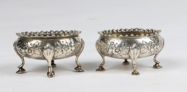 Appraisal: A PAIR OF VICTORIAN OVAL SHAPED SILVER SALTS with chased