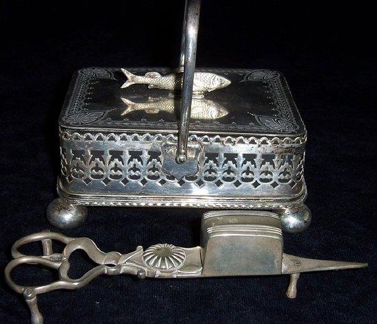 Appraisal: A sardine dish with swing handle and fish finial to