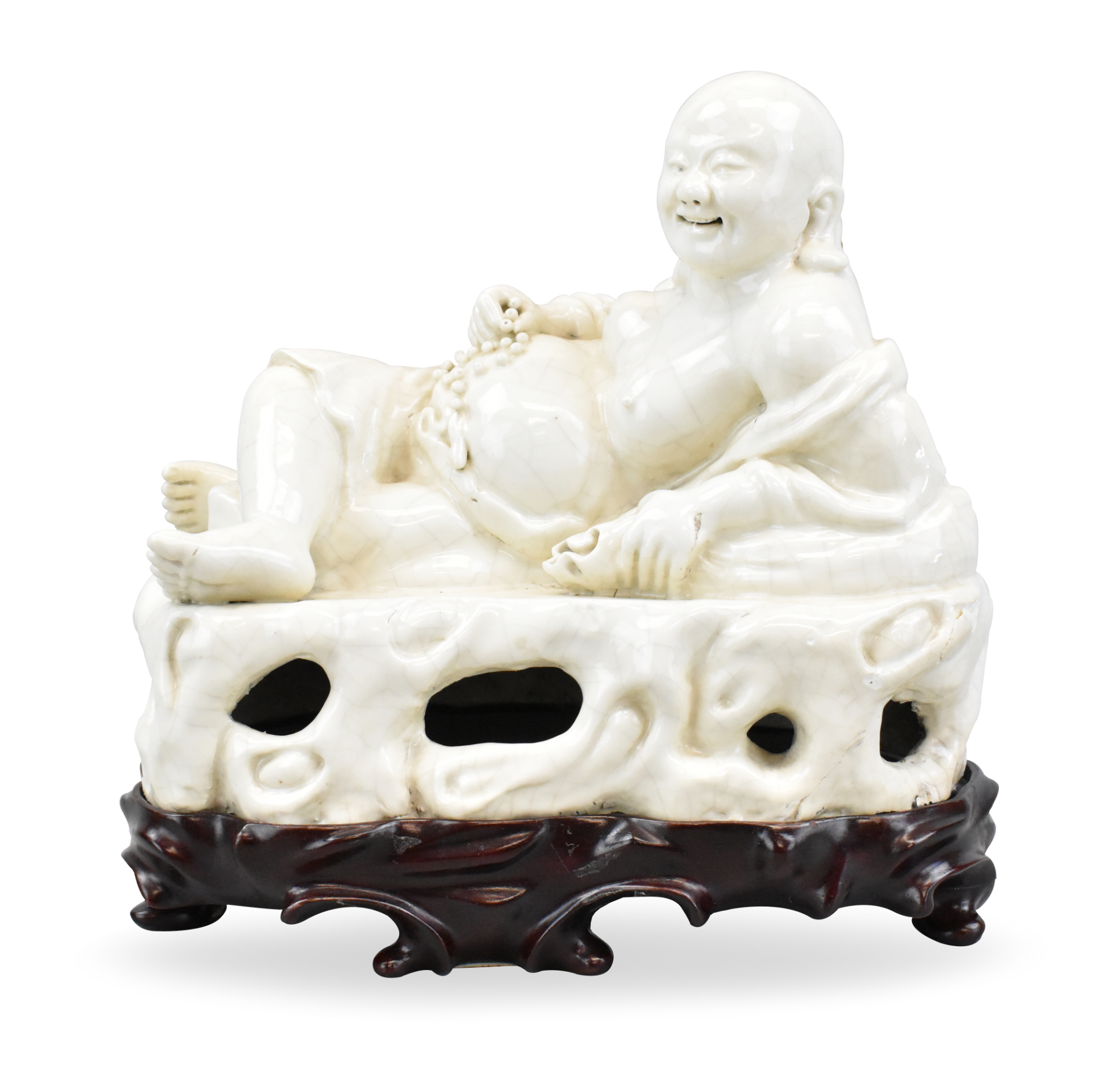 Appraisal: A Chinese zhangzhou ware reclining laughing buddha A jolly smiling