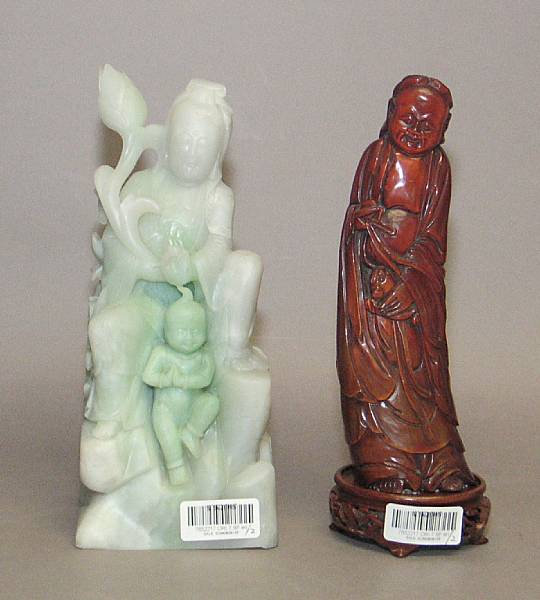 Appraisal: Two carved statues One of a dyed stone Guanyin chips